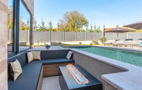 a pool with a bench next to a swimming pool at Cozy Home In Labin With Sauna in Labin
