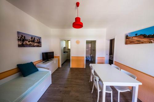 a living room with a white table and a couch at Golfo del Sole Hotel & Holiday Resort in Follonica