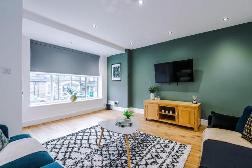 a living room with a couch and a tv at The Bridgeton In Harrogate - Parking - Garden in Harrogate