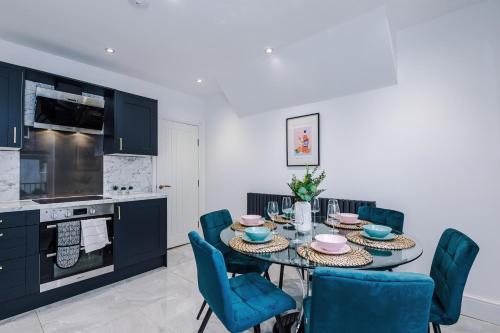 a kitchen with a dining room table and chairs at The Bridgeton In Harrogate - Parking - Garden in Harrogate