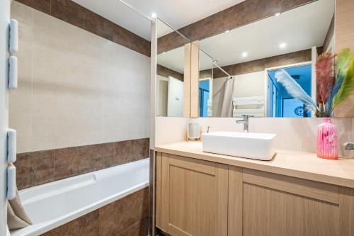 une salle de bain avec un lavabo, une baignoire et un miroir dans l'établissement Superb 2 bedroom in Nice, à Nice