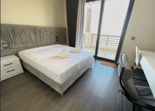 a bedroom with a bed with two towels on it at El Gouna - BIRD NEST in Hurghada