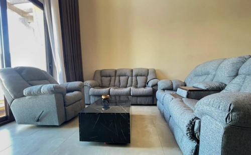 a living room with two couches and a coffee table at El Gouna - BIRD NEST in Hurghada