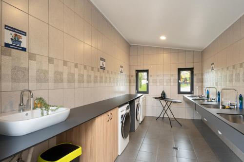 a bathroom with a sink and a washing machine at 7 Lakes camping in Sapareva Banya