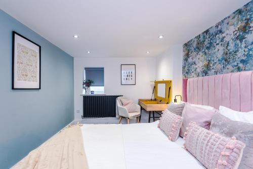 a bedroom with a large bed and a desk at The Bridgeton In Harrogate - Parking - Garden in Harrogate