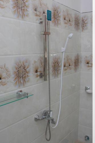 a shower in a bathroom with a shower head at Calm Nature Resort in Midigama