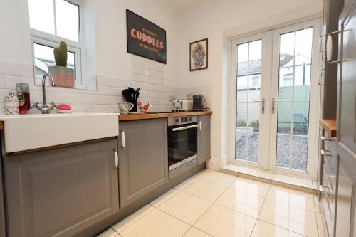 a kitchen with a sink and a counter top at Spacious 2-Bed Cardiff Haven with Luxe Touches in Cardiff