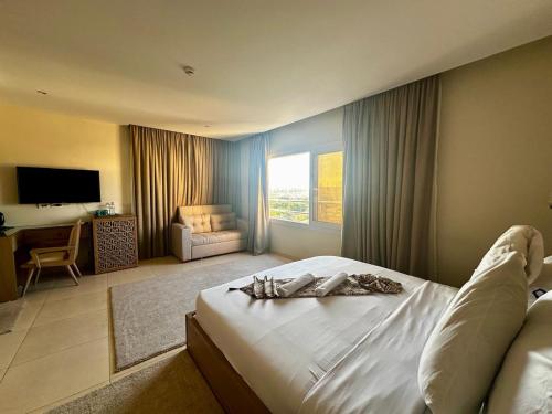 a hotel room with a bed and a living room at DouDou Pyramids View Hotel in Cairo