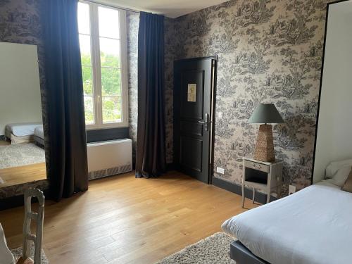 a bedroom with a bed and a window at Domaine de Bel Air in Cérans-Foulletourte