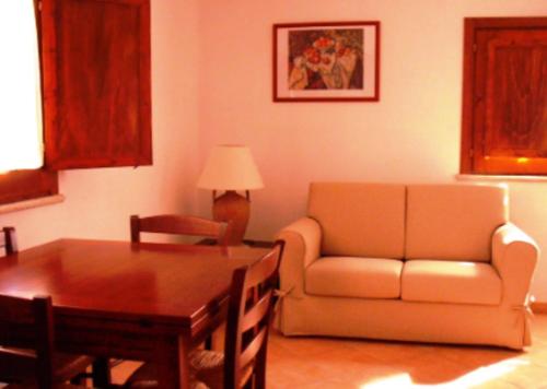 a living room with a couch and a table at Villaggio Del Sole in Giove