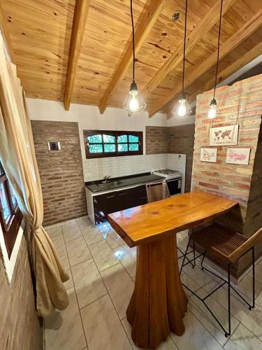 a dining room with a wooden table and a piano at Atrapa Sueños I in Embalse