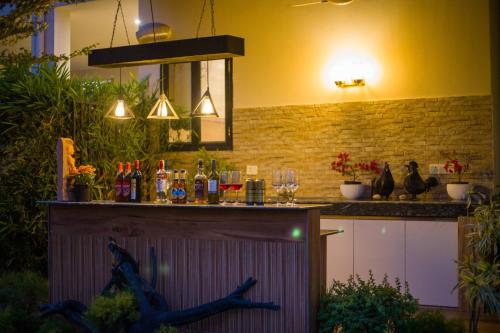 a bar with a counter with drinks on it at Alaya Stays Dacha 3 BHK Villa with Jacuzzi & Outdoor Bar in Palwal