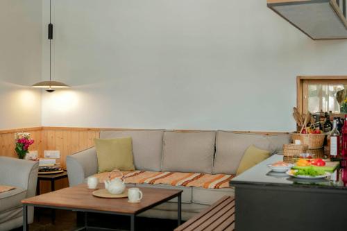 a living room with a couch and a table at StayVista at Gassa Home with Mountain View, BBQ, Lawn at Gangtok in Gangtok