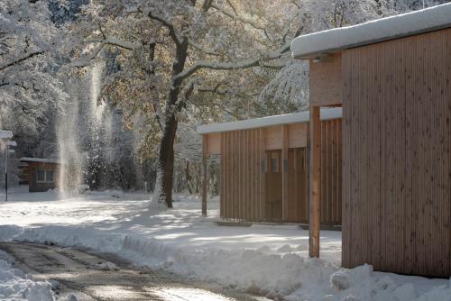 a small wooden building in the snow with a fountain at Apartment am Camping Dornbirn - 211 Hangspitze in Dornbirn