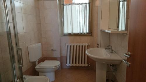 a bathroom with a toilet and a sink at Lakecomoweb Apartments in Perledo