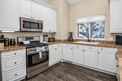 a kitchen with white cabinets and a stove top oven at 5025 Main Gore Place Condo in Vail