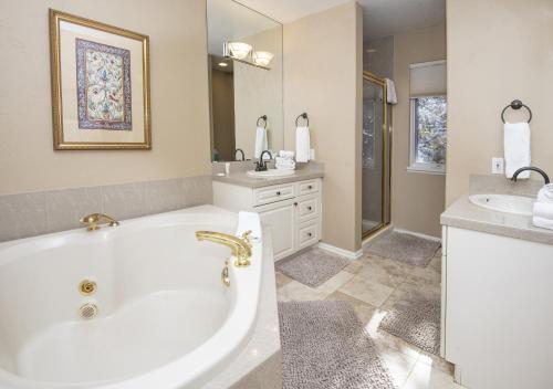 a white bathroom with a tub and a sink at 5025 Main Gore Place Condo in Vail