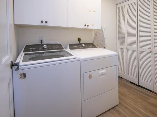 a white kitchen with a stove and a refrigerator at 5025 Main Gore Place Condo in Vail