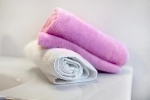 a pink and white towel sitting on a table at Apartments Antersi Robbi in San Vigilio Di Marebbe