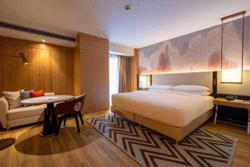a hotel room with a large bed and a couch at Cappadocia Marriott Hotel in Nevsehir