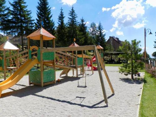 a playground with a slide in a park at TIZIANA HOME II - Appartamento ad Ovindoli - Residence Al Park in Ovindoli