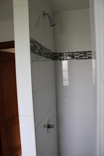 a bathroom with a shower with a glass door at Chez Ines in Marloie