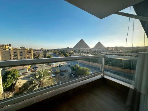 a view of the pyramids from the balcony of a building at DouDou Pyramids View Hotel in Cairo