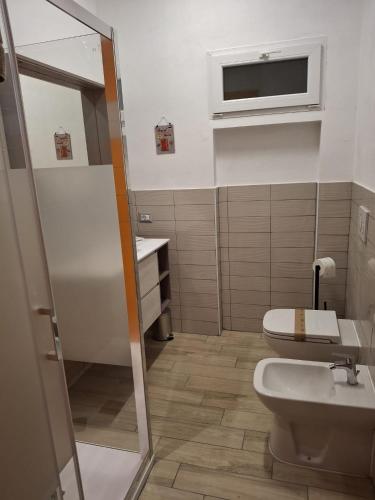 a bathroom with a toilet and a sink at CasaManù in Cesano Maderno