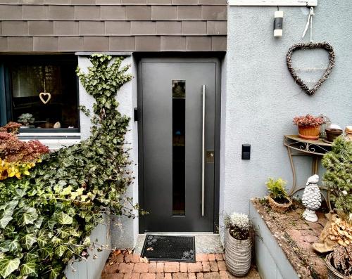 a black door on a house with plants at Apartment Fernwald mit Self-Check-In in Albach