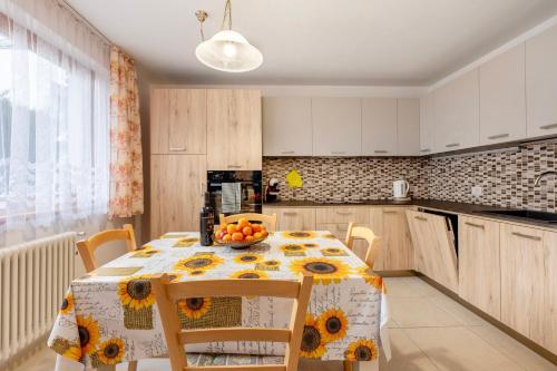 a kitchen with a table with sunflowers on it at Night and day 3 in Predazzo