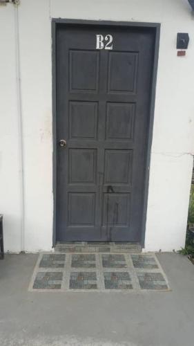 a black garage door with the number on it at D'semporna Homestay in Semporna