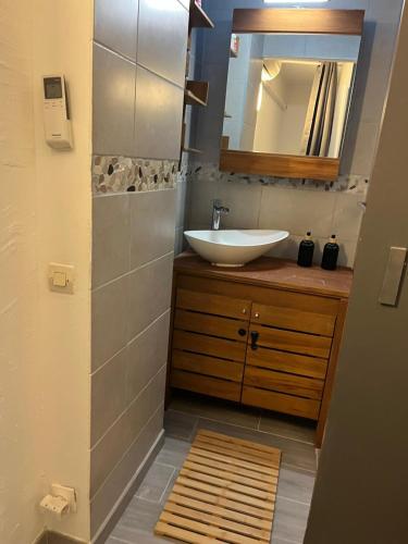 une salle de bain avec un lavabo et un miroir dans l'établissement Maison bord de mer, à La Seyne-sur-Mer