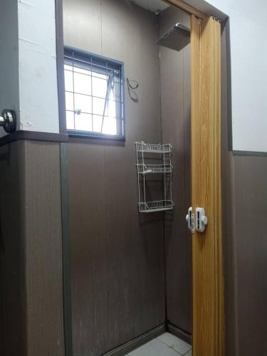 a bathroom with a shower with a window at D'semporna Homestay in Semporna