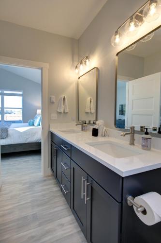 a bathroom with a sink and a large mirror at Burl By The Bay in Ocean Shores
