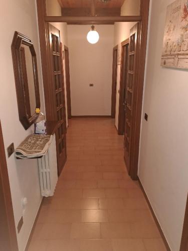 a hallway of a room with doors and a tile floor at Appartamento Montefumaiolo in Balze