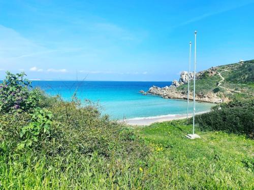 a view of the ocean from a hill with a beach at Your Exclusive Apartment near Santa Teresa Gallura in Porto Pozzo
