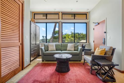 a living room with a couch and a table at Luana Waikiki Hotel & Suites in Honolulu