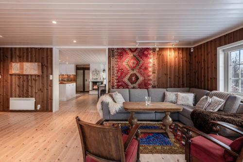 a living room with a couch and a table at Sunny and beautiful cabin in Geilo in Geilo