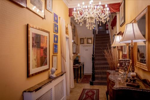 a hallway of a home with a chandelier at Hotel Rouge in Blackpool