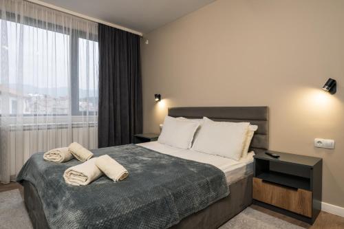 a hotel room with a bed with towels on it at City Apartments 4 in Velingrad