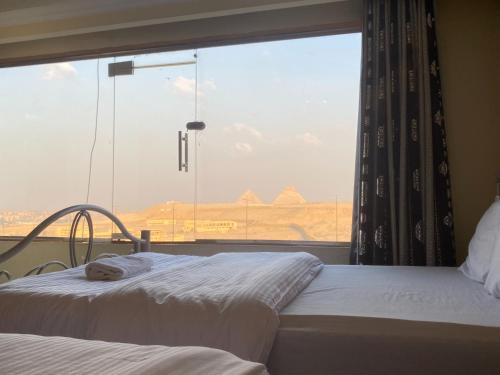 Postel nebo postele na pokoji v ubytování Pyramita Hotel