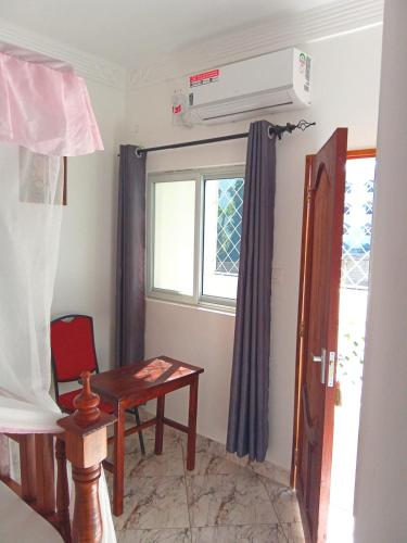 a small room with a table and a window at Milalana Guest Hotel & Residences in Malindi