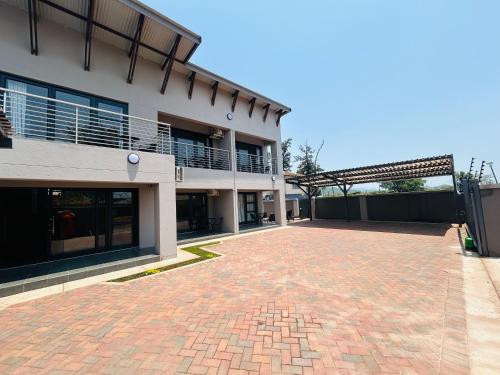 a brick driveway in front of a building at Chill Out in Malelane