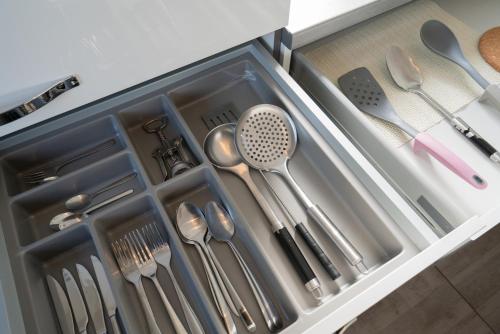 a drawer filled with utensils in a kitchen at Domus Optima - Cozy Retreat in Vienna in Vienna
