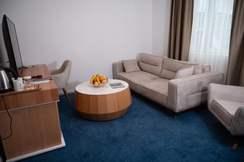 a living room with a couch and a coffee table at Hotel Borovi Forest Resort & Spa in Sjenica