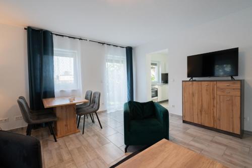 a living room with a table and a flat screen tv at Domus Optima - Cozy Retreat in Vienna in Vienna