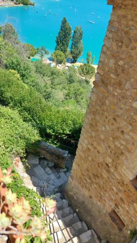 a stone tower with a view of a beach and the ocean at chambres d'hôtes Les Fenières in Sainte-Croix-de-Verdon