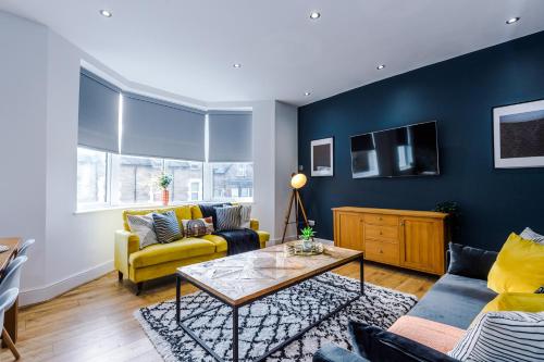 a living room with a couch and a table at The Harrogate Hub - 6 Bedrooms & Pool Table in Harrogate