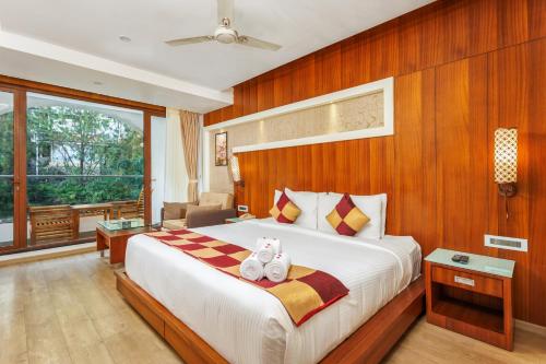 Ένα ή περισσότερα κρεβάτια σε δωμάτιο στο Amber Dale Luxury Hotel & Spa, Munnar