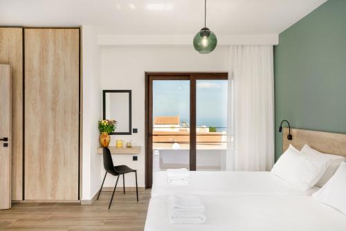 a bedroom with a bed and a desk and a chair at Olimpia Villas I Luxury villas with private pools! in Epáno Kefalás